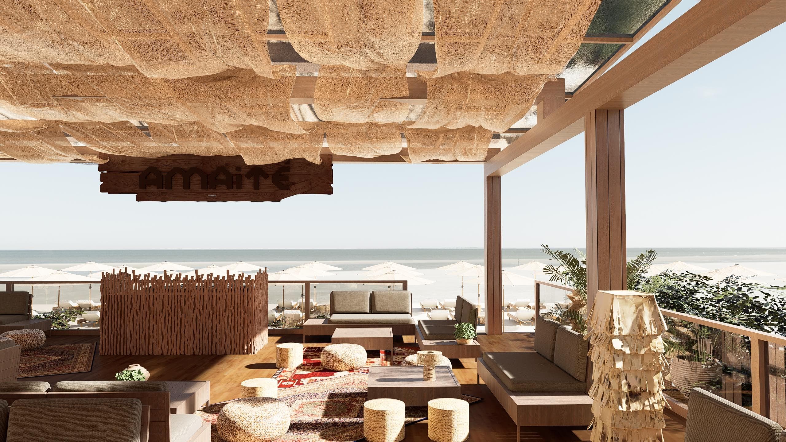 Deck do Amaité de frente para o mar, com lounges sob telas de palha e guarda-sóis na areia